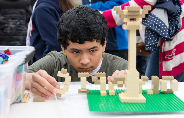 Boy creating a masterpiece with legos at the Atlanta Science Festival